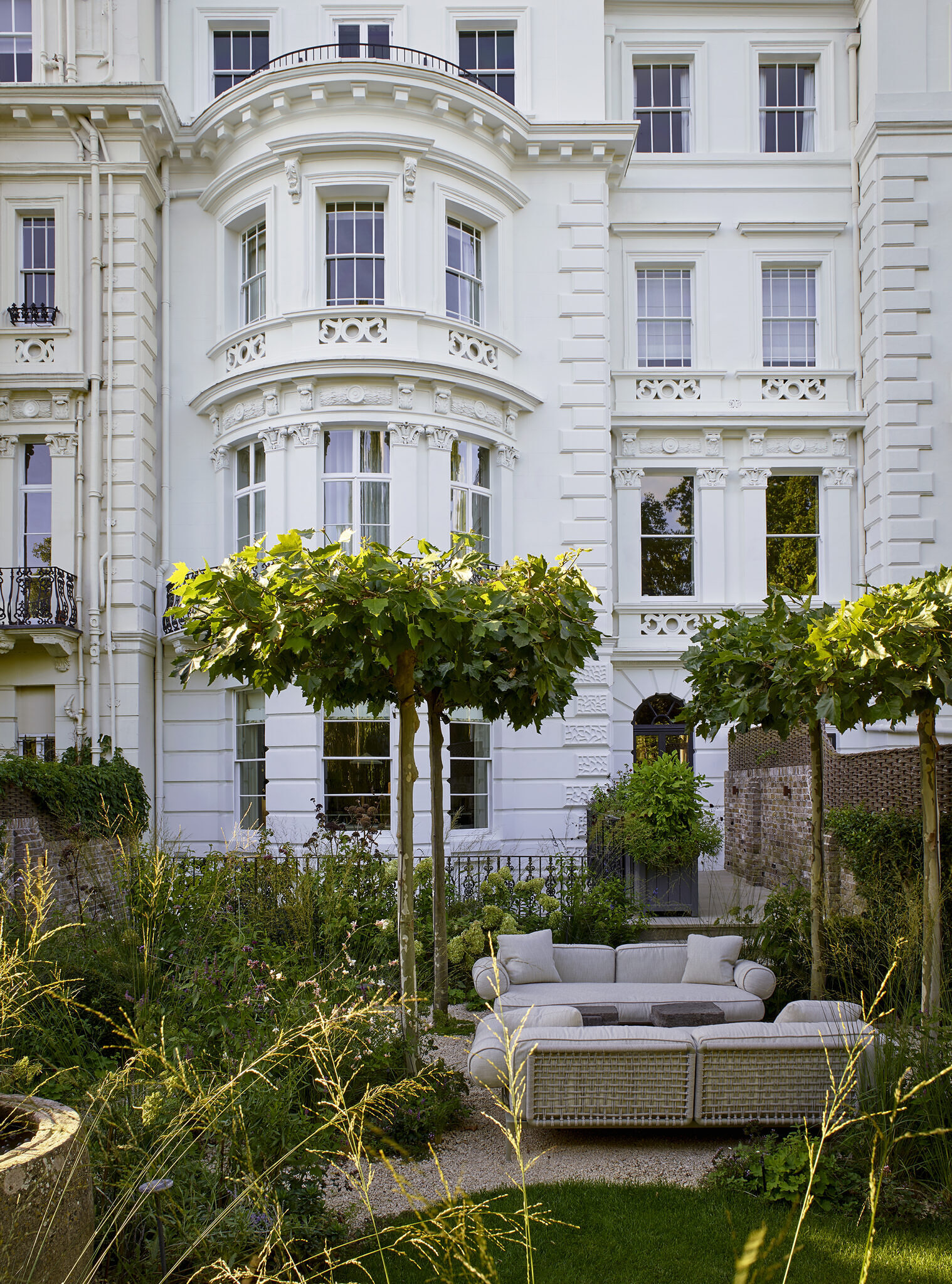 Exterior backyard image of a garden with a seating area.